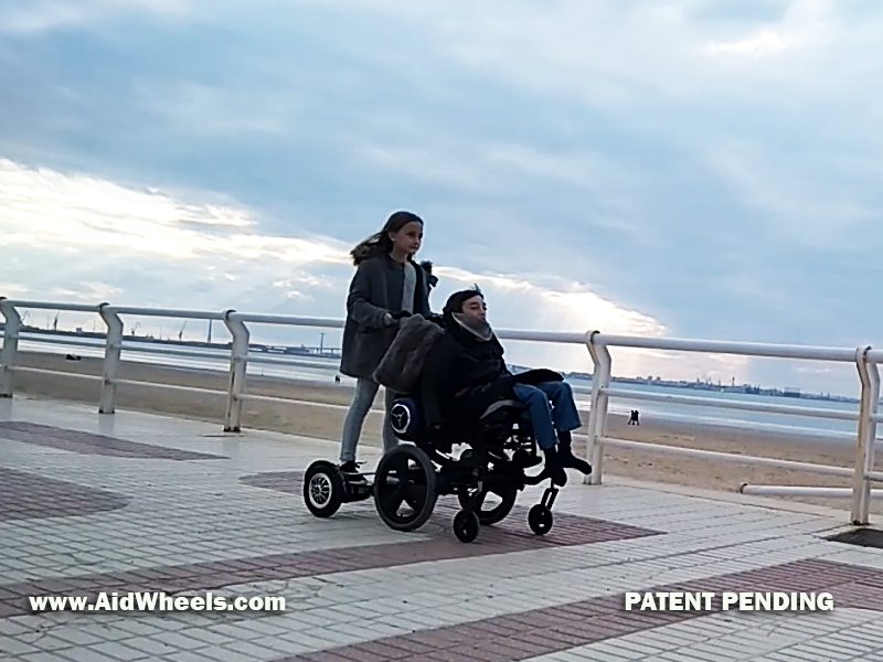 pushing wheelchair with hoverboard